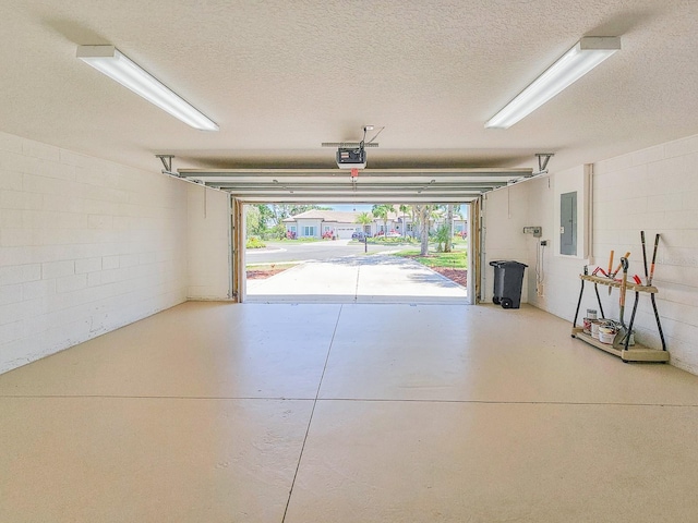 71 N Riverwalk Dr, Palm Coast, FL 32137 - garage featuring a garage door opener, electric panel, and concrete block wall