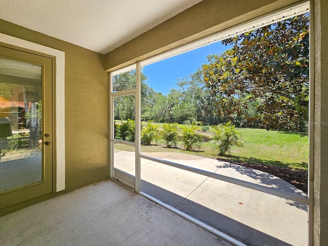 71 N Riverwalk Dr, Palm Coast, FL 32137 - unfurnished sunroom featuring view of scattered trees