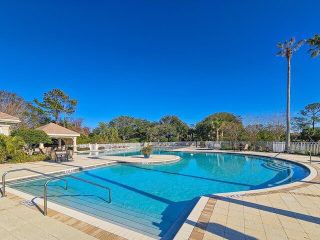 71 N Riverwalk Dr, Palm Coast, FL 32137 - community pool featuring fence, a gazebo, and a patio area