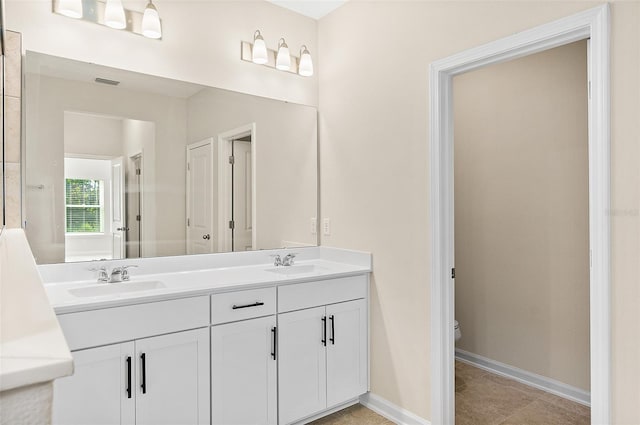 137 Nighthawk Ln, Palm Coast, FL 32164 - full bathroom with toilet, double vanity, and baseboards