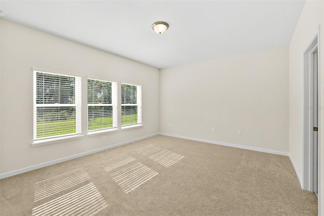 137 Nighthawk Ln, Palm Coast, FL 32164 - spare room featuring light carpet and baseboards