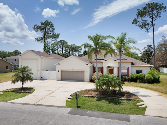 91 Breeze Hill Ln, Palm Coast, FL 32137 - ranch-style home with curved driveway, stucco siding, a garage, and a front lawn