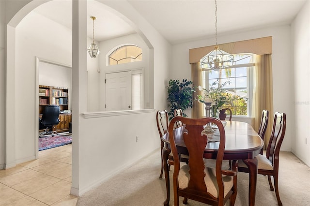 91 Breeze Hill Ln, Palm Coast, FL 32137 - dining area with a chandelier, arched walkways, baseboards, and light colored carpet