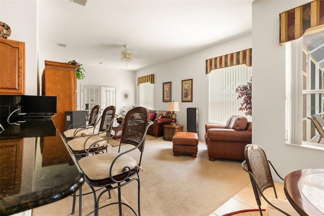 91 Breeze Hill Ln, Palm Coast, FL 32137 - dining room with light carpet, healthy amount of natural light, and light tile patterned flooring