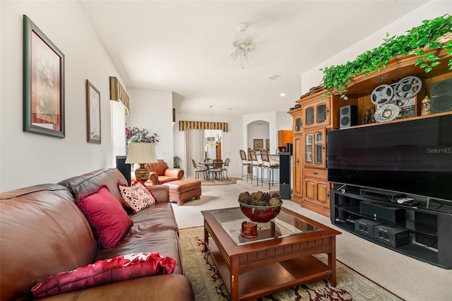 91 Breeze Hill Ln, Palm Coast, FL 32137 - living room featuring light colored carpet, ceiling fan, and arched walkways