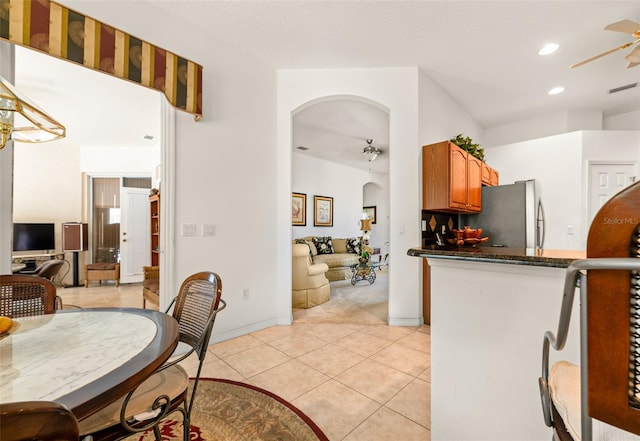 91 Breeze Hill Ln, Palm Coast, FL 32137 - kitchen featuring arched walkways, freestanding refrigerator, ceiling fan, open floor plan, and recessed lighting