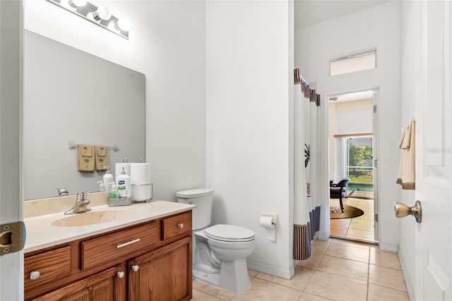 91 Breeze Hill Ln, Palm Coast, FL 32137 - bathroom with vanity, tile patterned flooring, toilet, and baseboards