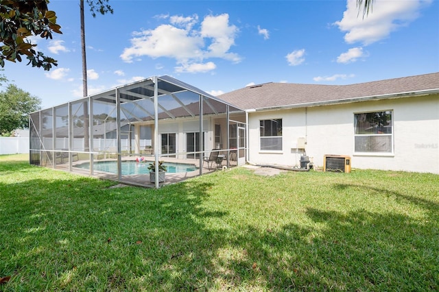 91 Breeze Hill Ln, Palm Coast, FL 32137 - back of house featuring a lawn, stucco siding, and glass enclosure