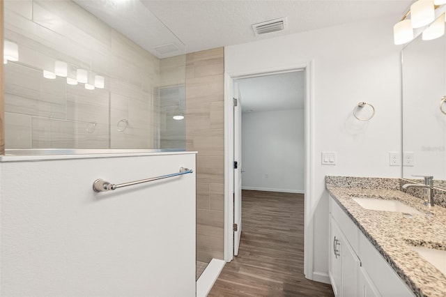 19 Ethel Ln, Palm Coast, FL 32164 - full bathroom with walk in shower, wood finished floors, double vanity, and baseboards