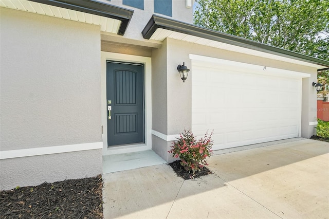 19 Ethel Ln, Palm Coast, FL 32164 - view of exterior entry featuring stucco siding and driveway