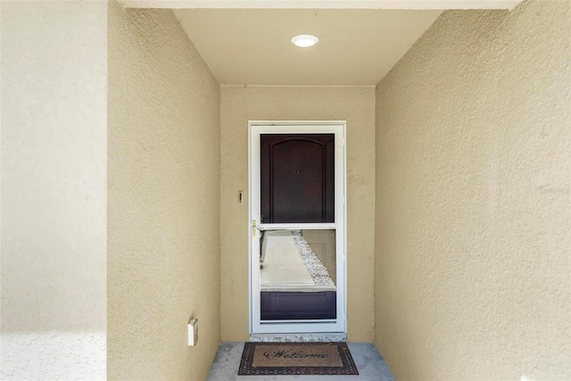 9 Waldron Pl, Palm Coast, FL 32164 - doorway to property featuring stucco siding