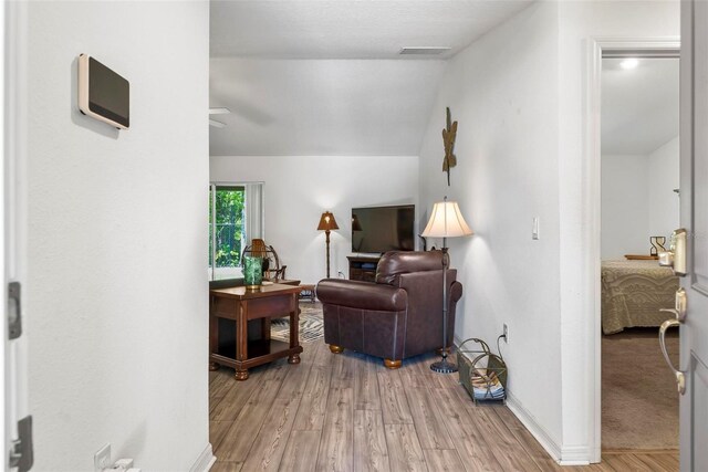 9 Waldron Pl, Palm Coast, FL 32164 - living area with light wood-style floors, vaulted ceiling, ceiling fan, and baseboards