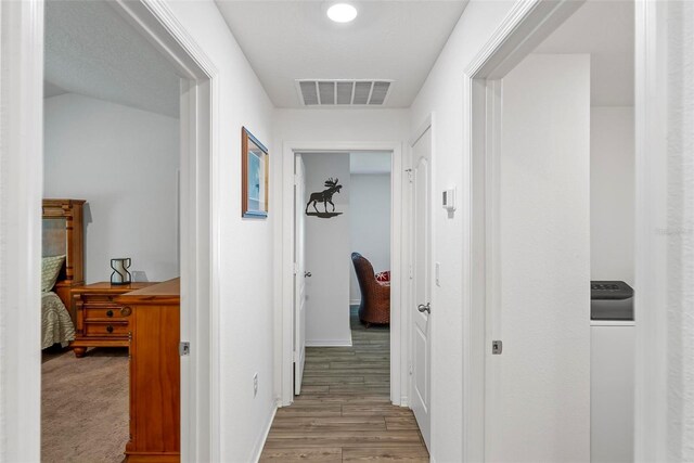 9 Waldron Pl, Palm Coast, FL 32164 - corridor featuring wood finished floors, washer / clothes dryer, and baseboards