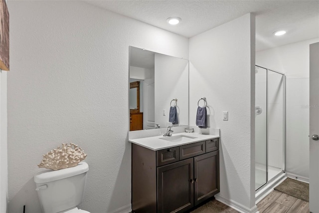 9 Waldron Pl, Palm Coast, FL 32164 - bathroom with a stall shower, toilet, vanity, wood finished floors, and a textured wall