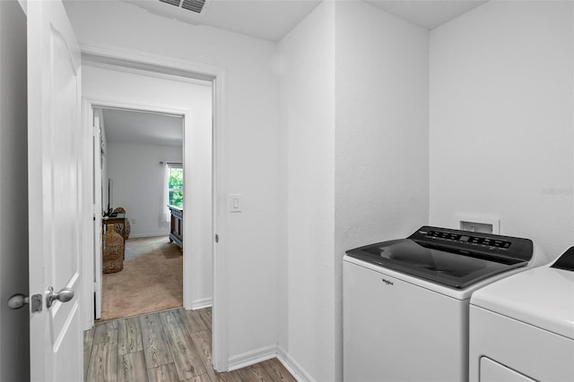 9 Waldron Pl, Palm Coast, FL 32164 - washroom featuring independent washer and dryer, light wood-style flooring, and baseboards