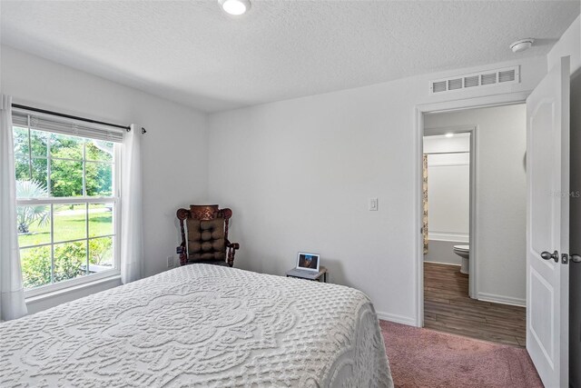 9 Waldron Pl, Palm Coast, FL 32164 - bedroom featuring carpet flooring, a textured ceiling, and baseboards