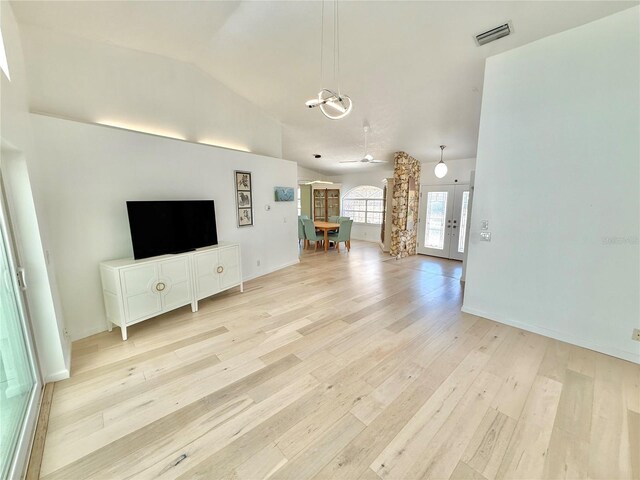 4 Cotton Ct, Palm Coast, FL 32137 - living area featuring light wood finished floors, vaulted ceiling, ornate columns, a chandelier, and baseboards