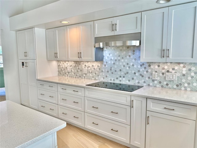 4 Cotton Ct, Palm Coast, FL 32137 - kitchen with wall chimney range hood, decorative backsplash, black electric cooktop, and white cabinets