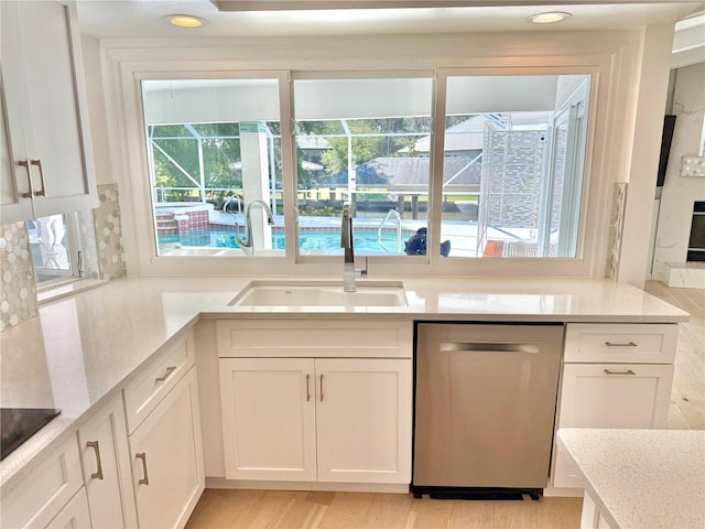 4 Cotton Ct, Palm Coast, FL 32137 - kitchen featuring dishwasher, a sink, white cabinets, plenty of natural light, and recessed lighting