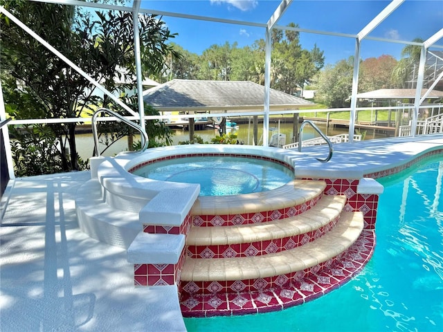 4 Cotton Ct, Palm Coast, FL 32137 - view of pool with a lanai, a pool with connected hot tub, and view of wooded area