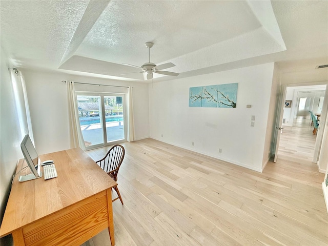 4 Cotton Ct, Palm Coast, FL 32137 - home office featuring a raised ceiling, ceiling fan, a textured ceiling, light wood-type flooring, and baseboards