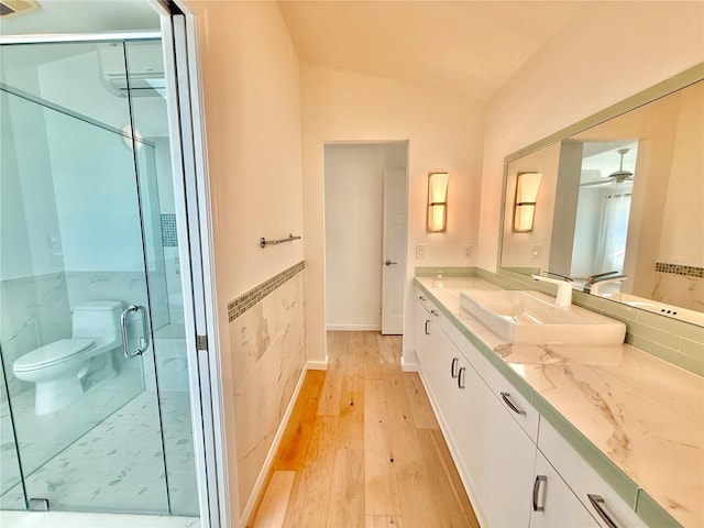 4 Cotton Ct, Palm Coast, FL 32137 - full bathroom with wood finished floors, vanity, a wall mounted AC, toilet, and a marble finish shower