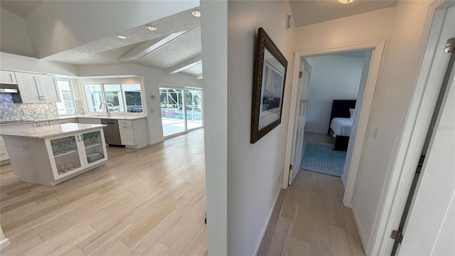 4 Cotton Ct, Palm Coast, FL 32137 - kitchen with dishwasher, light countertops, light wood-type flooring, a sink, and tasteful backsplash