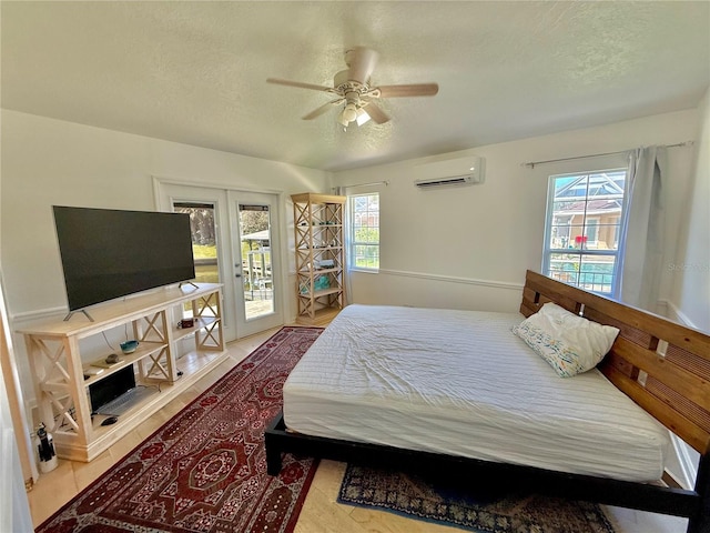 4 Cotton Ct, Palm Coast, FL 32137 - bedroom featuring a wall mounted air conditioner, access to exterior, a textured ceiling, french doors, and ceiling fan