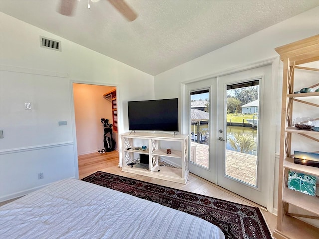 4 Cotton Ct, Palm Coast, FL 32137 - bedroom with french doors, access to outside, lofted ceiling, wood finished floors, and a textured ceiling