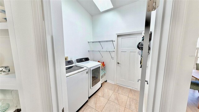 4 Cotton Ct, Palm Coast, FL 32137 - laundry area with a skylight, washing machine and dryer, and light tile patterned floors