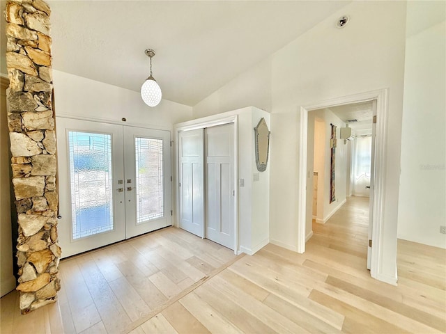 4 Cotton Ct, Palm Coast, FL 32137 - entrance foyer featuring french doors, light wood-style flooring, and vaulted ceiling
