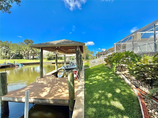 4 Cotton Ct, Palm Coast, FL 32137 - dock with a water view, a yard, boat lift, and a lanai