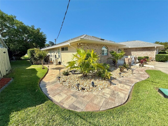 4 Cotton Ct, Palm Coast, FL 32137 - rear view of house featuring a lawn and brick siding