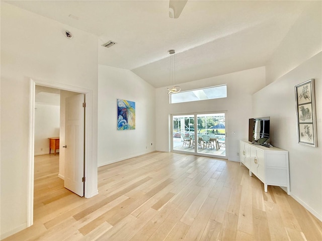 4 Cotton Ct, Palm Coast, FL 32137 - unfurnished living room with light wood-style flooring, high vaulted ceiling, and baseboards