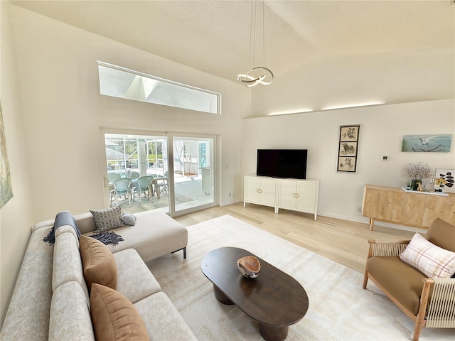 4 Cotton Ct, Palm Coast, FL 32137 - living area with light wood-style flooring, a high ceiling, and baseboards