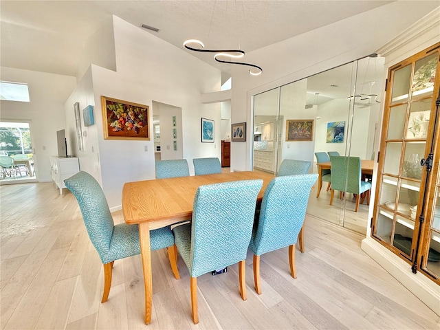 4 Cotton Ct, Palm Coast, FL 32137 - dining room featuring light wood-type flooring and lofted ceiling