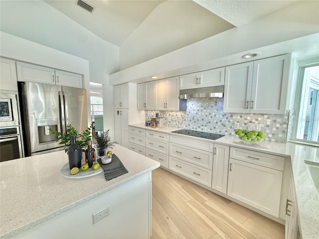 4 Cotton Ct, Palm Coast, FL 32137 - kitchen with stainless steel appliances, backsplash, under cabinet range hood, light wood-style flooring, and light stone counters