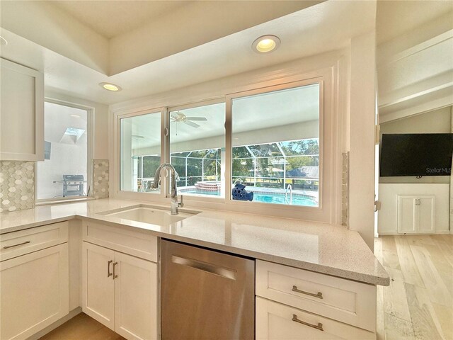 4 Cotton Ct, Palm Coast, FL 32137 - kitchen featuring stainless steel dishwasher, a sink, healthy amount of natural light, light stone counters, and recessed lighting