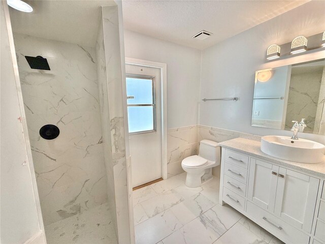 4 Cotton Ct, Palm Coast, FL 32137 - bathroom featuring marble look tiles, tile walls, a marble finish shower, vanity, and toilet