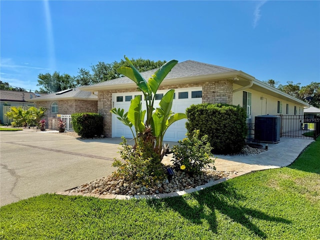 4 Cotton Ct, Palm Coast, FL 32137 - view of front of home featuring an attached garage, cooling unit, brick siding, driveway, and a gate