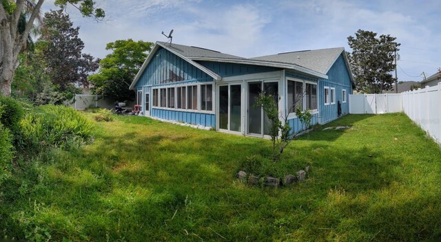 20 Eastgate Ln, Palm Coast, FL 32164 - view of side of property featuring a sunroom and roof with shingles