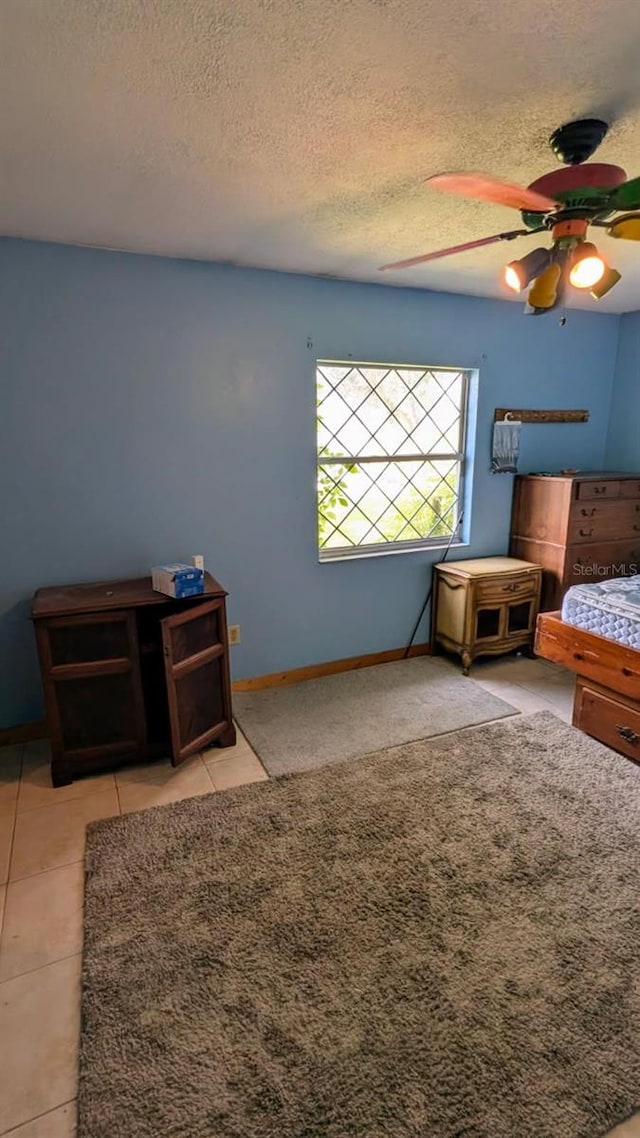 20 Eastgate Ln, Palm Coast, FL 32164 - unfurnished bedroom with a textured ceiling, ceiling fan, and baseboards