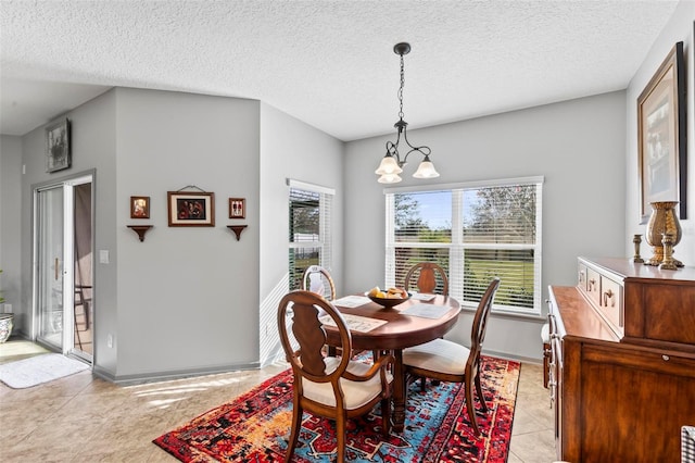 123 N Starling Dr, Palm Coast, FL 32164 - dining room with a chandelier, light tile patterned floors, a textured ceiling, and baseboards