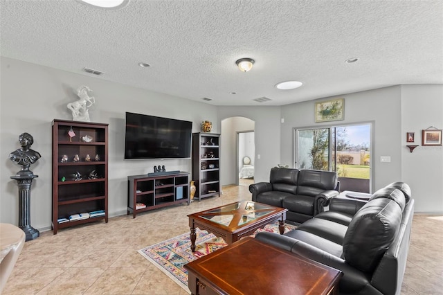 123 N Starling Dr, Palm Coast, FL 32164 - living area featuring arched walkways, light tile patterned floors, and a textured ceiling