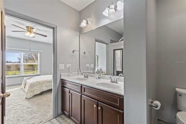 123 N Starling Dr, Palm Coast, FL 32164 - full bathroom with a ceiling fan, toilet, double vanity, and ensuite bath