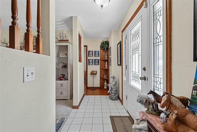 foyer with light tile patterned floors and baseboards