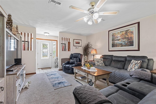 living area with a ceiling fan and light carpet