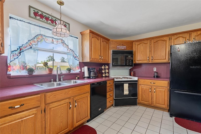 kitchen featuring black appliances, a sink, brown cabinetry, light tile patterned floors, and decorative light fixtures