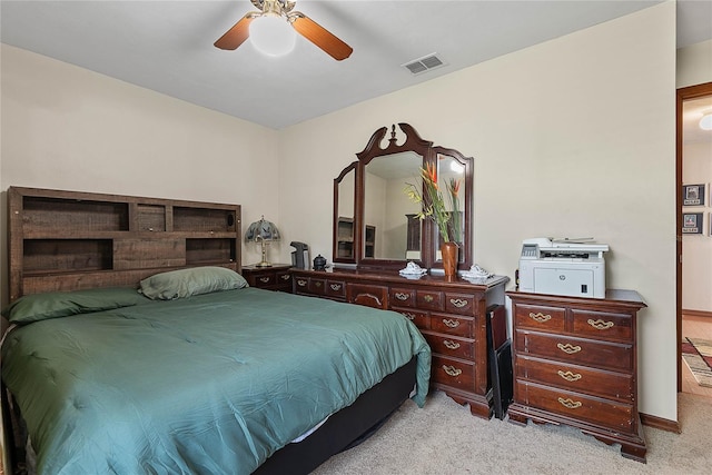 carpeted bedroom featuring a ceiling fan and baseboards