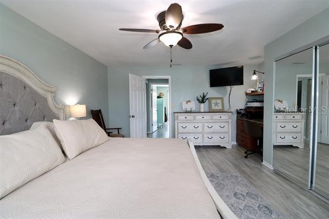 5 N Ocean Palm Villa N Unit 5, Flagler Beach, FL 32136 - bedroom with light wood-style flooring, ceiling fan, and a closet